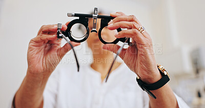 Buy stock photo Optometrist, trial frame and glasses with hands of woman in clinic for eye exam, healthcare and vision. Medical, ophthalmologist and lens with person and tools for retina, visual test and assessment