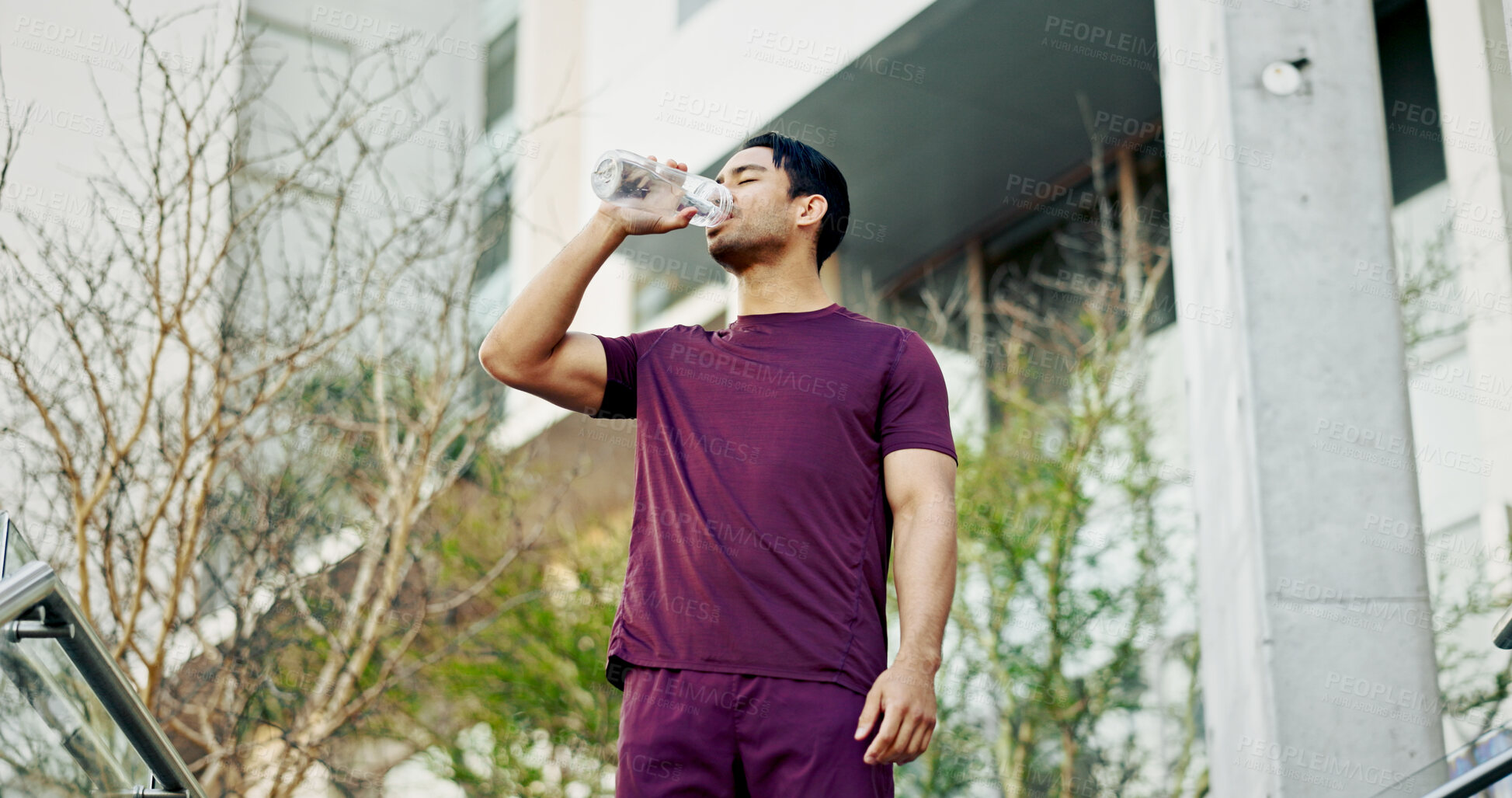 Buy stock photo Man, drinking water and city athlete on break, liquid nutrition and sports drink for fitness. Male person, relax and bottle of h2o for refreshing rest in urban town, training and exercise recovery