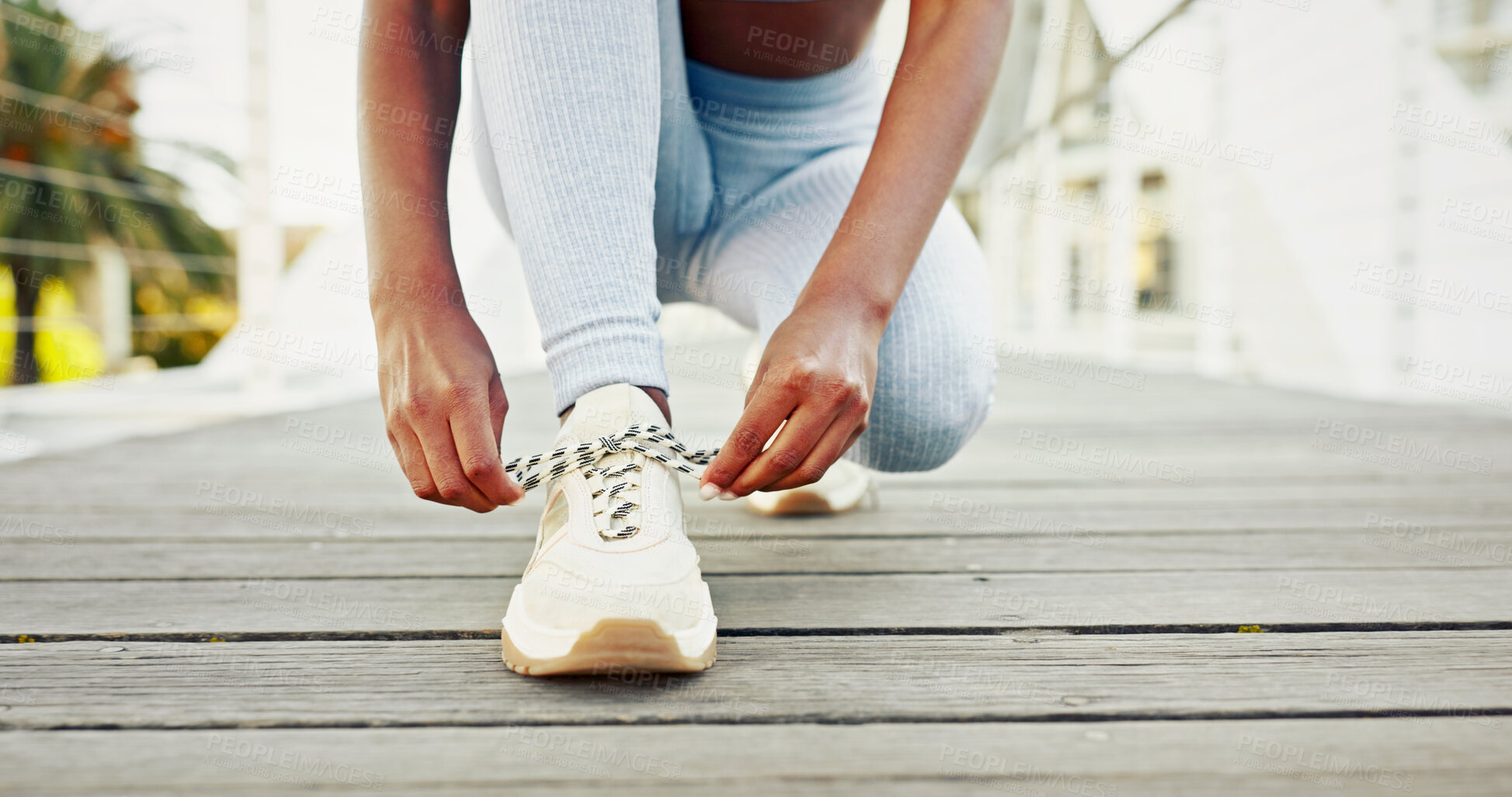 Buy stock photo Woman, tying shoes and city athlete for getting ready, running training and outdoor for activity. Female person, fitness preparation and urban bridge for footwear, strong legs and tie laces in town