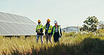 People, discussion and technician with team for solar panel installation, photovoltaic development or PV project. Group, engineer or contractors walking with helmet for renewable energy or power