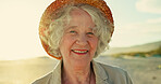 Portrait, senior woman and beach for retirement or holiday with health, peace and wellness. Elderly, female person and confidence for happiness by ocean for vacation, relax and adventure as pensioner