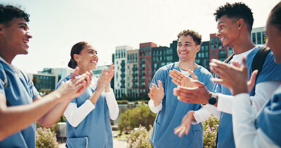 Buy stock photo Medical success, students and happy with applause outdoor for health training feedback or board exam results. Diversity, people or celebration in circle for healthcare practice and residency approval