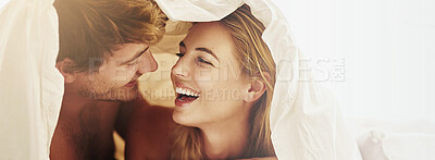 Buy stock photo Blanket, happy and couple on bed in morning for relax, playful relationship and bonding in home. Dating, banner and man and woman smile, wake up and laugh for romance, affection and love on weekend