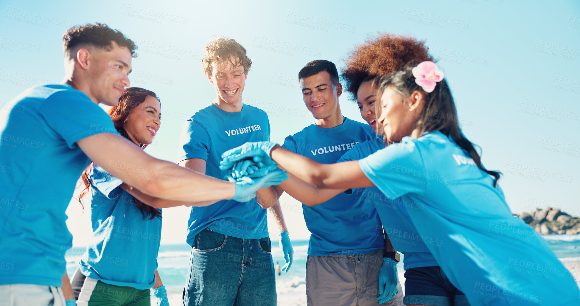 Buy stock photo Beach, volunteer and people with hands together for support, motivation and community service. Climate change, pollution and recycling team for ocean clean up, collaboration and social responsibility