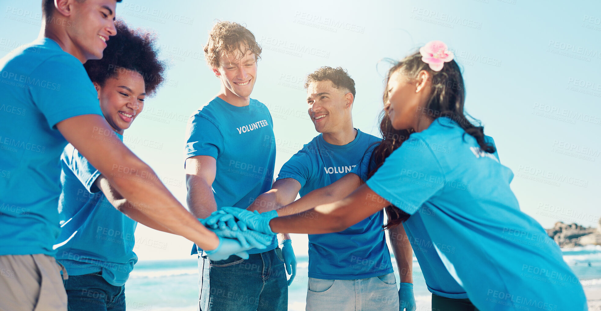 Buy stock photo Beach, volunteer and people with hands together for teamwork, support and community service. Climate change, recycling and friends in circle for ocean clean up, collaboration or social responsibility