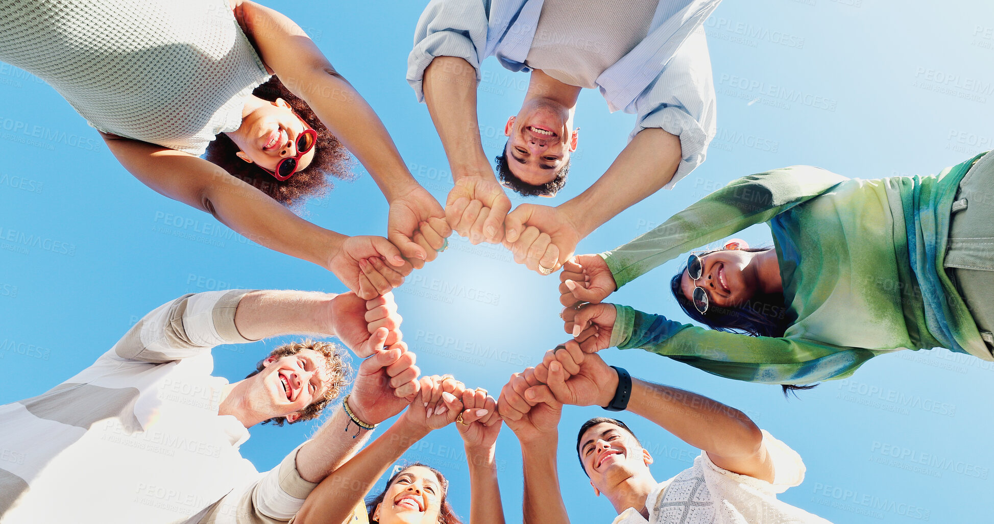 Buy stock photo Fist bump, low angle and hands with friends and outdoors for support, community and motivation. Solidarity, teamwork and diversity with people in nature for collaboration, happiness and connection