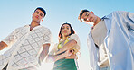 Portrait, sky and group of people on beach with confidence, sunshine or outdoor adventure holiday together. Friends, men and woman in nature with travel vacation, bonding or arms crossed on low angle