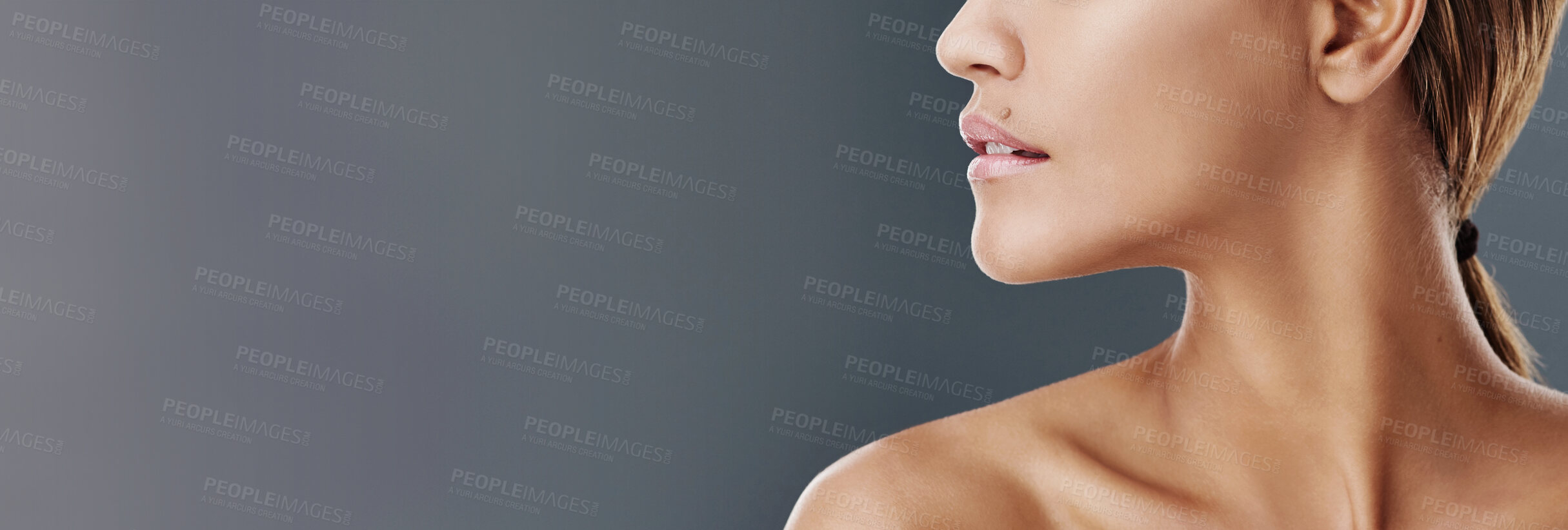 Buy stock photo Woman, lips and skincare with beauty on mockup space or banner for cosmetology or dermatology. Closeup, female person or profile of model with skin glow, shine or gloss on a gray studio background