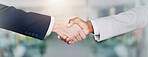 Closeup, business people and handshake for support, teamwork and cooperation for project. Employees, coworking and consultant with thank, gratitude and banner with greeting, partnership and welcome