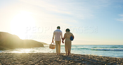 Buy stock photo Back, holding hands and picnic with couple on beach together for romantic holiday or vacation. Basket, love and walking with people on sand at ocean or sea for travel to tropical island paradise