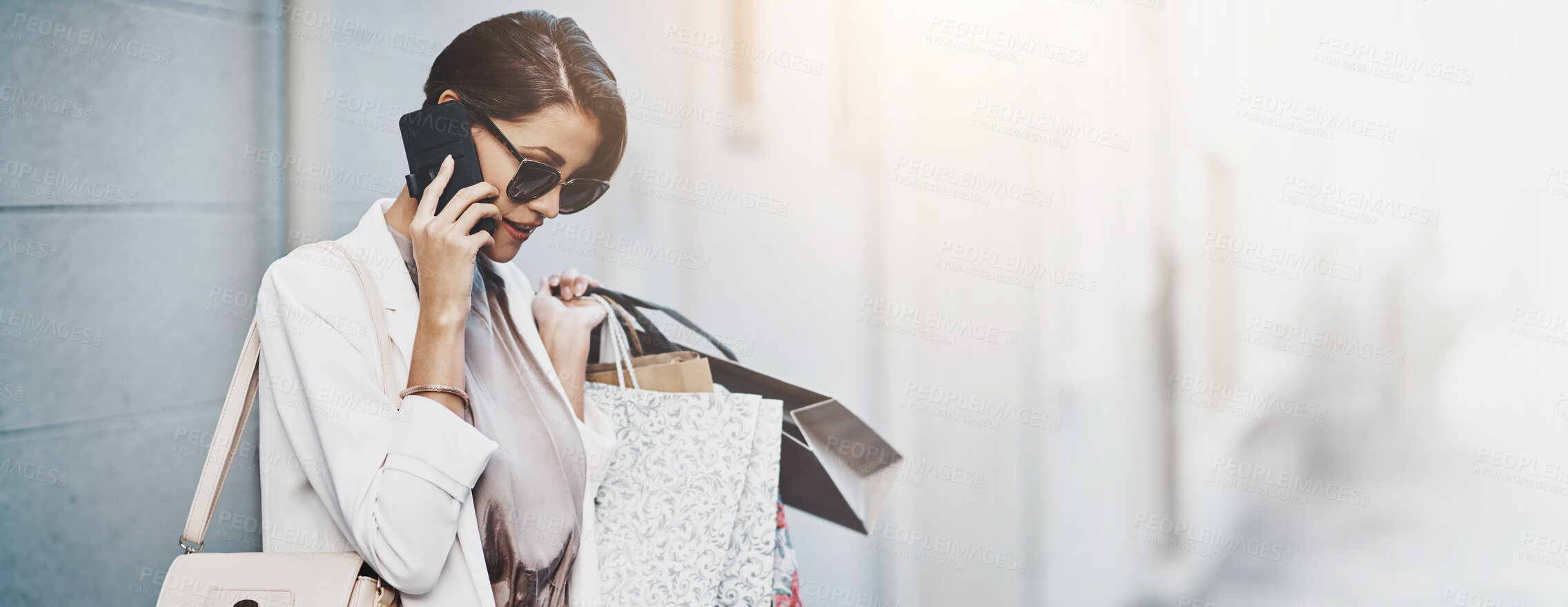 Buy stock photo Woman, shopping bag and phone call for fashion in city, wall or check for transport booking. Person, banner and thinking with style, sale and smartphone for contact with taxi driver on road in France