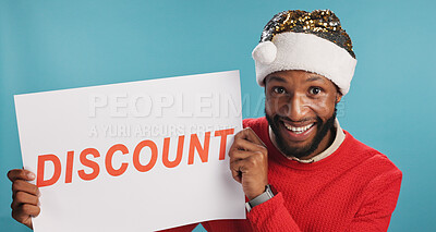 Buy stock photo Paper, happy and portrait of black man in studio with advertisement for discount or promotion. Excited, board and African male person with sign for deal with christmas shopping by blue background.