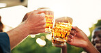 Hands, friends and cheers with glass of beer with smile outdoor for celebration, reunion and gathering. People, closeup and happiness with alcohol or liquor beverage for toast and special occasion