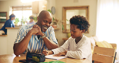 Buy stock photo Kitchen, studying and child with dad, smile and support for son, growth or development with education. Bonding, black man and assistance for homework, writing and kid with knowledge, teaching or home