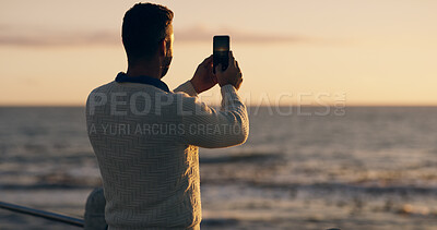 Buy stock photo Man, beach and phone for photo at sunset on promenade with memory, vacation and back with web in summer. Person, smartphone and outdoor on holiday with profile picture for social network in Australia