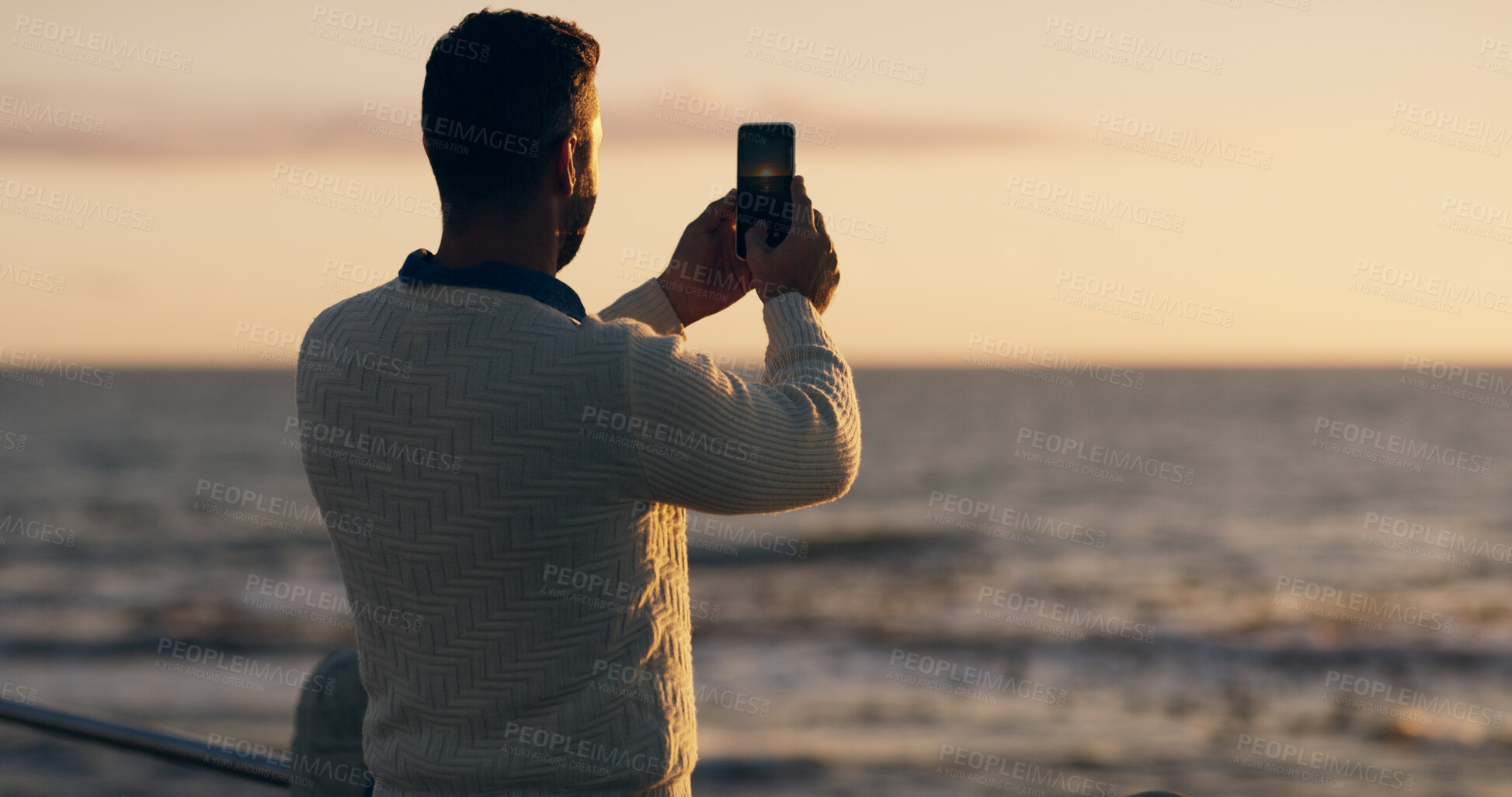 Buy stock photo Man, beach and phone for photo at sunset on promenade with memory, vacation and back with web in summer. Person, smartphone and outdoor on holiday with profile picture for social network in Australia