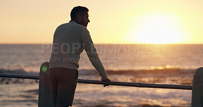 Buy stock photo Man, thinking and outdoor by sea, sunrise or promenade in summer with decision in morning on break. Person, pier and inspiration by ocean, beach or reflection with sky, back and dawn in New Zealand