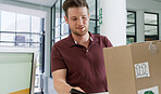 Man, delivery and office with box for logistics, courier service or online order at front desk. Male person, transport or package with parcel, cargo or shipment for import or export distribution