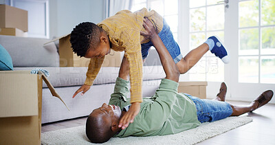 Buy stock photo New home, playing or father with child in air for playful bonding, relocation or property on living room floor. Black family, dad and son with smile or boxes for aeroplane, holiday or moving in house