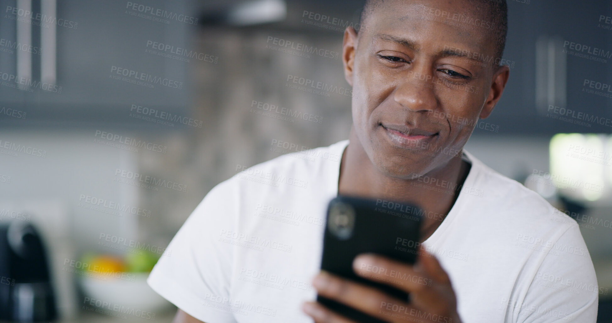 Buy stock photo Black man, phone and home for typing message, morning communication and surfing social media news. Male person, chatting and online for entertainment in kitchen, reading ebook and internet on weekend