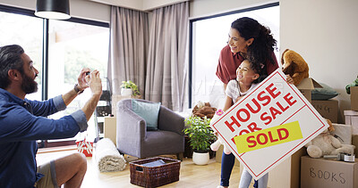 Buy stock photo Family, people and picture with real estate sign at new house for property relocation, moving in memory or excited. Parents, child and photo with sold board in home for milestone or social media post
