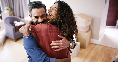 Buy stock photo Happy couple, hug and celebrate moving in new home, relocation success and homeowners for mortgage. People, embrace and proud of real estate achievement in living room, support and house security