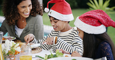 Buy stock photo Christmas, family and eating lunch by home for festive celebration, bonding or conversation outdoor. Food, woman or happy children on patio for holiday dinner, social gathering or fun with santa hat