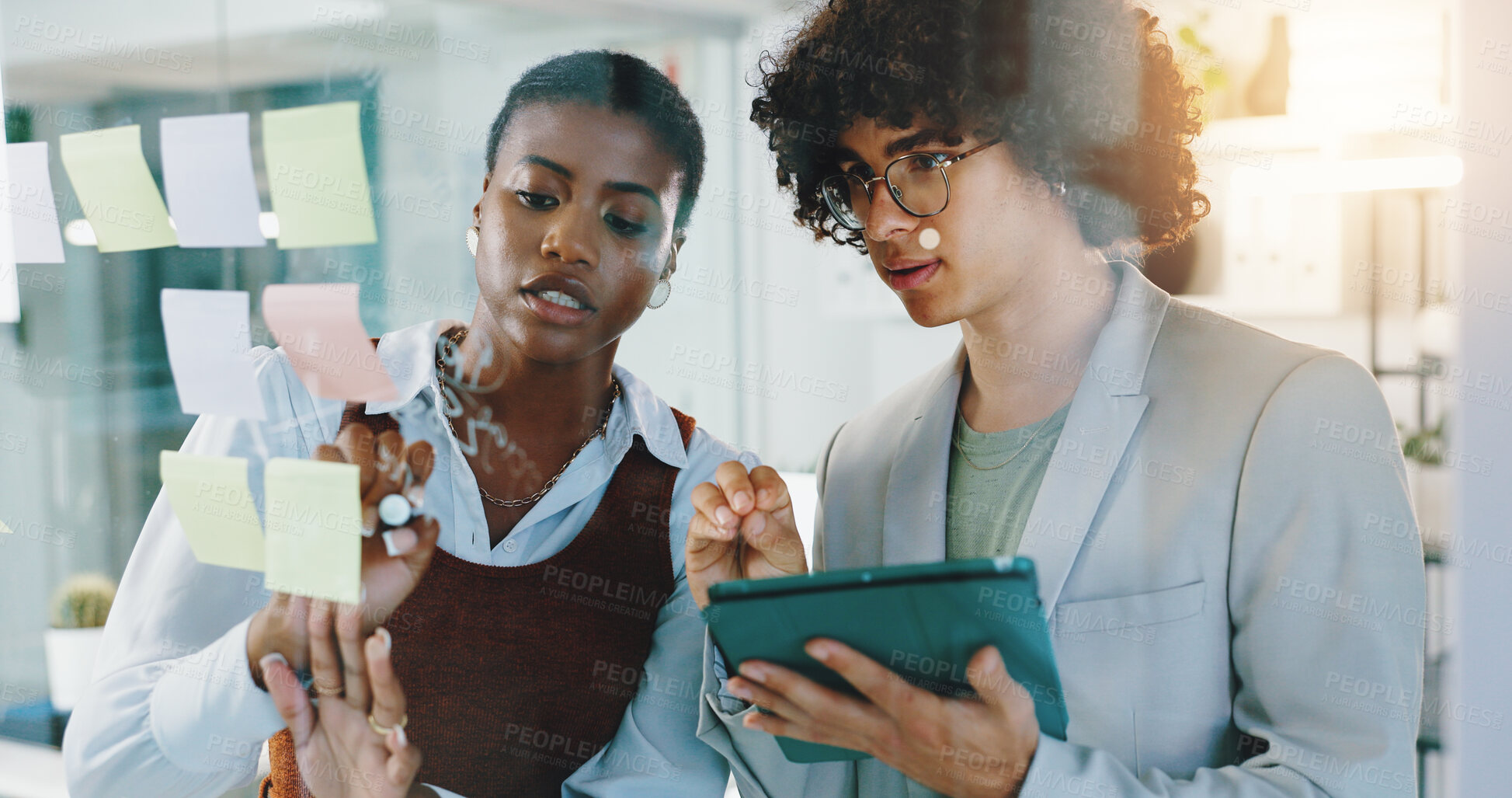 Buy stock photo Woman, man and tablet with notes by glass wall with writing, discussion and problem solving at office. Business people, board and touchscreen with partnership, app and planning at creative agency