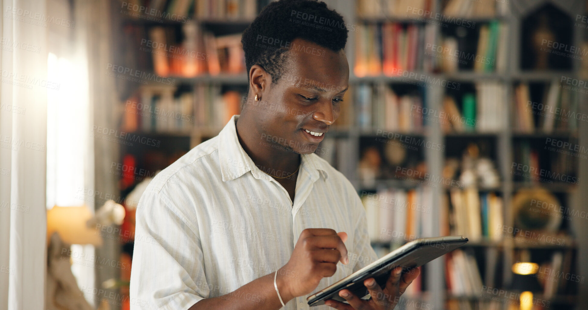 Buy stock photo Library, student and black man with tablet for education, college website and check results for exam. Home, happy person and reading with digital for university research, test information or learning