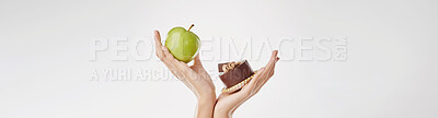Buy stock photo Person, hands and apple with chocolate dessert for diet choice, decision or option on a white studio background. Banner, closeup or model with organic fruit or cacao cake for balance on mockup space