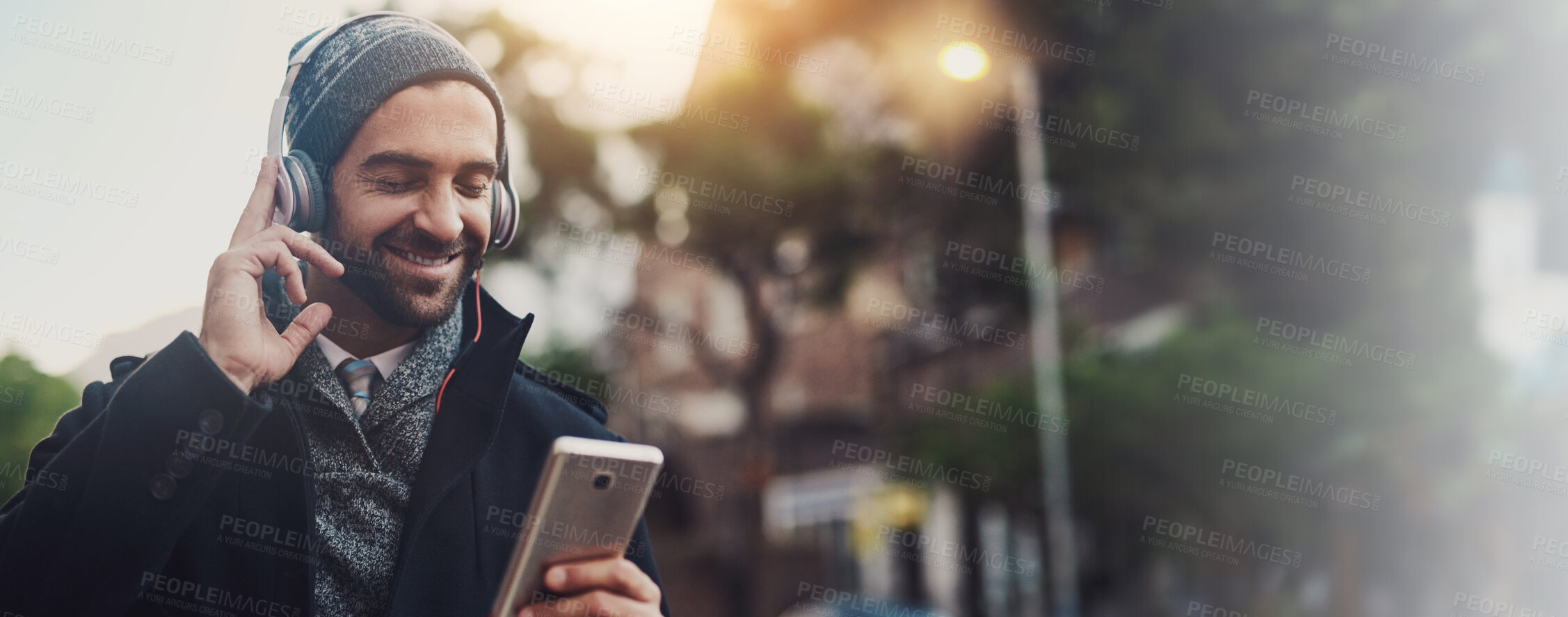 Buy stock photo Headphones, music and smile with man in city for streaming, online audio and podcast. Happiness, connection and phone with person in urban town with mobile app for banner, playlist and subscribe