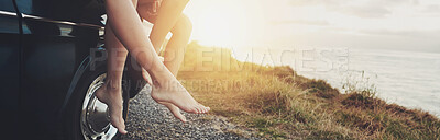 Buy stock photo Feet, car and ocean at sunset, road trip and outdoor on journey, vacation and break in summer. People, legs and transport with vehicle on holiday, nature and sunshine at beach, sea or hill in France