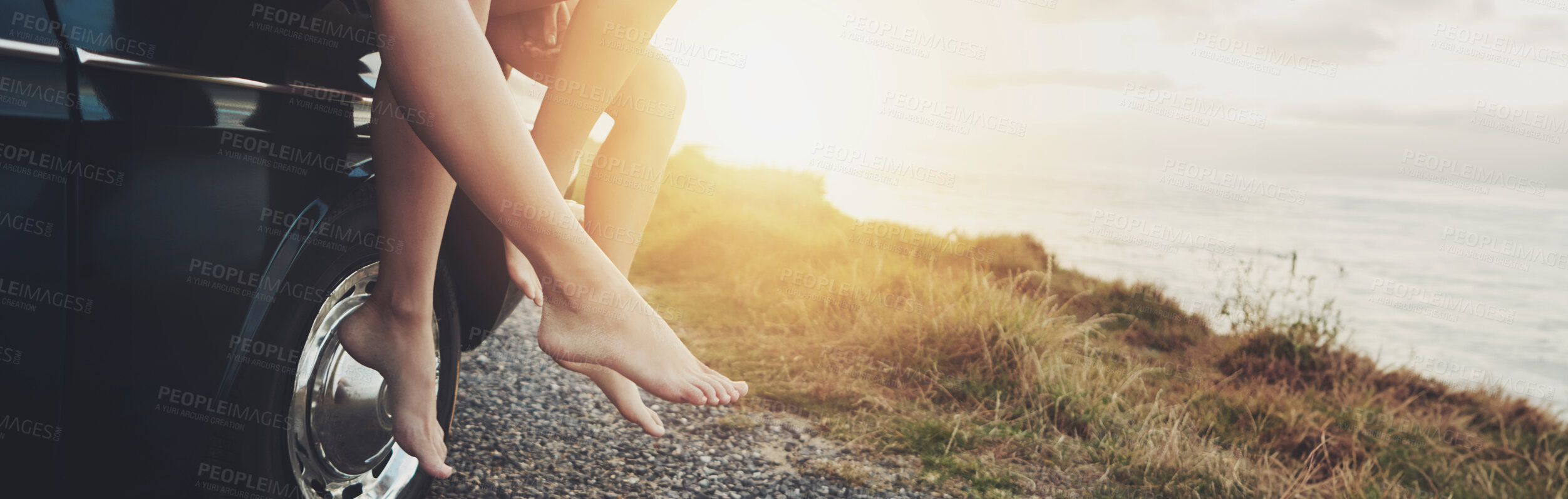 Buy stock photo Feet, car and ocean at sunset, road trip and outdoor on journey, vacation and break in summer. People, legs and transport with vehicle on holiday, nature and sunshine at beach, sea or hill in France