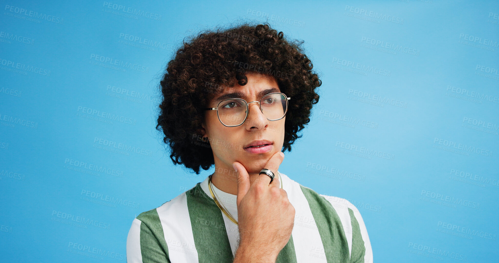 Buy stock photo Thinking, doubt face and man with glasses for brainstorming, problem solving or idea on blue background in studio. Why, questions or model with plan emoji for solution, memory or guess expression