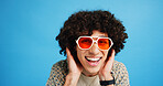 Happy man, portrait and sunglasses with funky style for fashion on a blue studio background. Face, male person or hipster model with smile, afro or curly hair for stylish accessory on mockup space