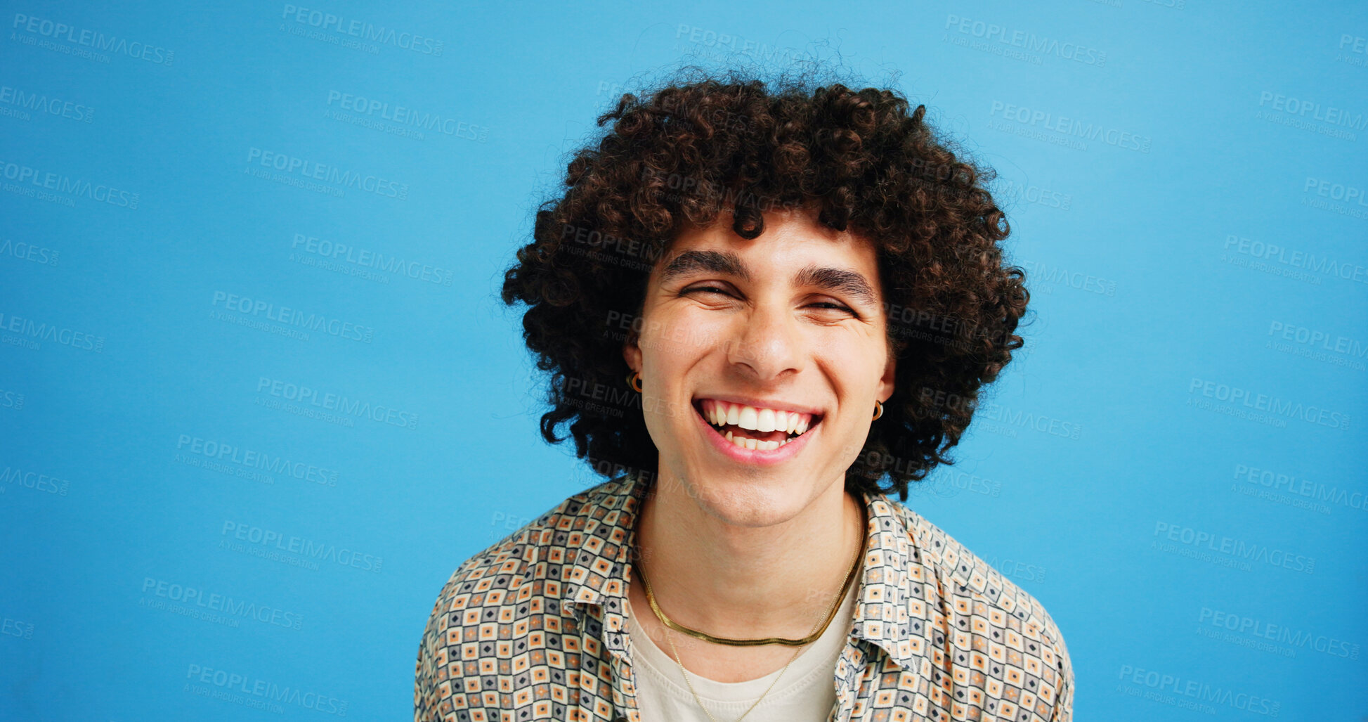 Buy stock photo Happy man, portrait and student in studio with fashion, funny joke and excited at space. Person, brand style and laugh on blue background for scholarship approval, comedy or accessories for aesthetic