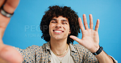 Buy stock photo Selfie, wave or portrait of happy man in studio with hand gesture, video call or fashion clothes. Smile, greeting or influencer on blue background for social media streaming, photo or vlogging pov