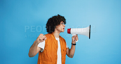 Buy stock photo Man, profile and protest with bullhorn in studio for strike, announcement or communication on a blue background. Male person, rebel or march with loudspeaker for awareness, alert or message on space