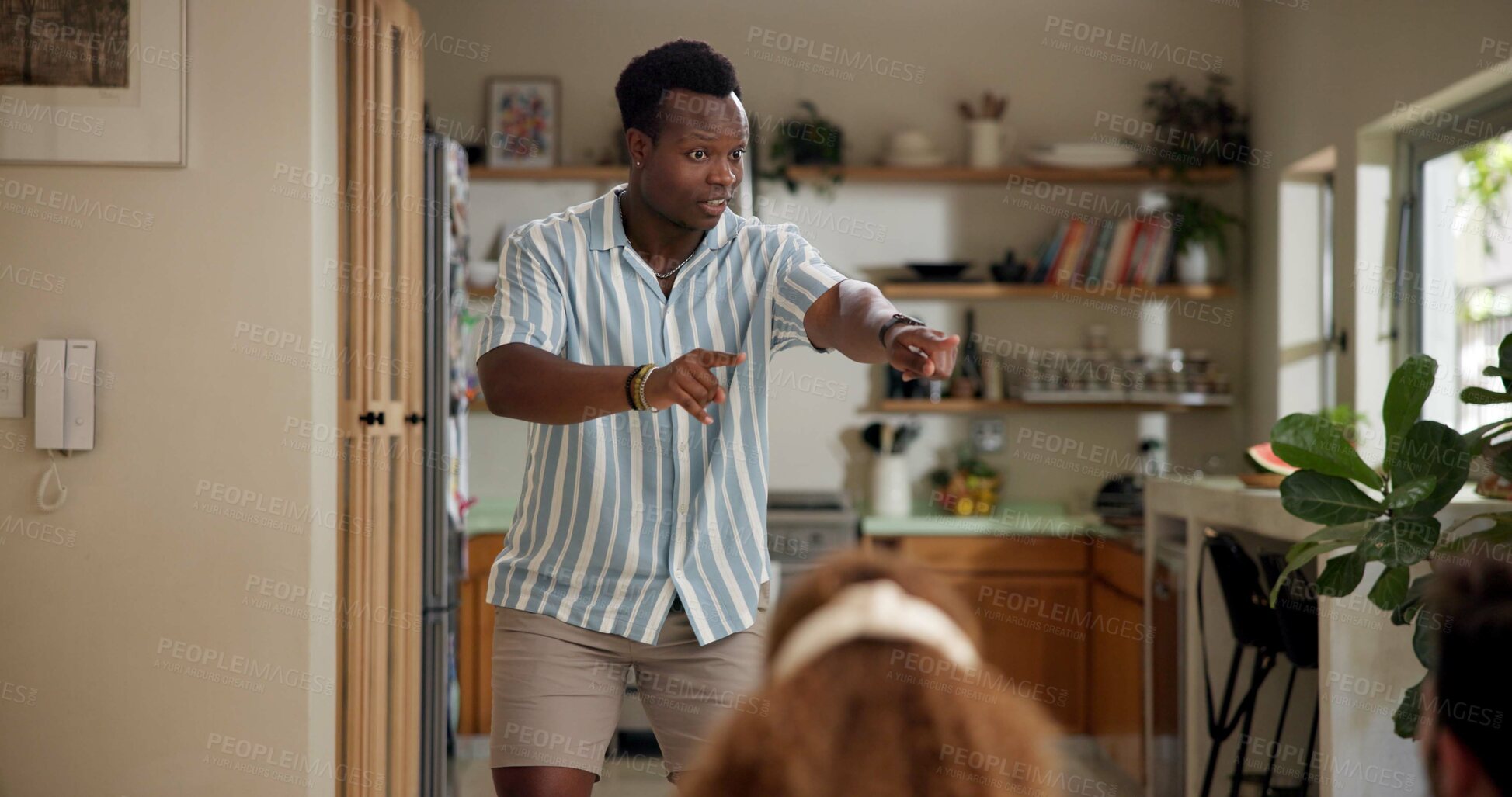 Buy stock photo Man, clue game and pointing in home with friends for challenge, fun and bonding together. Person acting, playing pantomime and party for weekend, social gathering or activity in living room at house