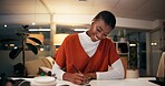 Happy, black woman and writing with book at night for online research, schedule or planning dates at office. African, female person or journalist working late or taking notes for business reminder