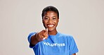 Happy, black woman or volunteer with finger pointing to you for choice or selection on a white studio background. Portrait, African or female person with gesture for pick, community service or option