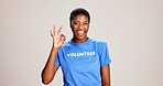 OK, sign and volunteer woman with portrait on studio background for NGO project success and approval. Black person, happy and perfect emoji on mockup space for charity support and community service