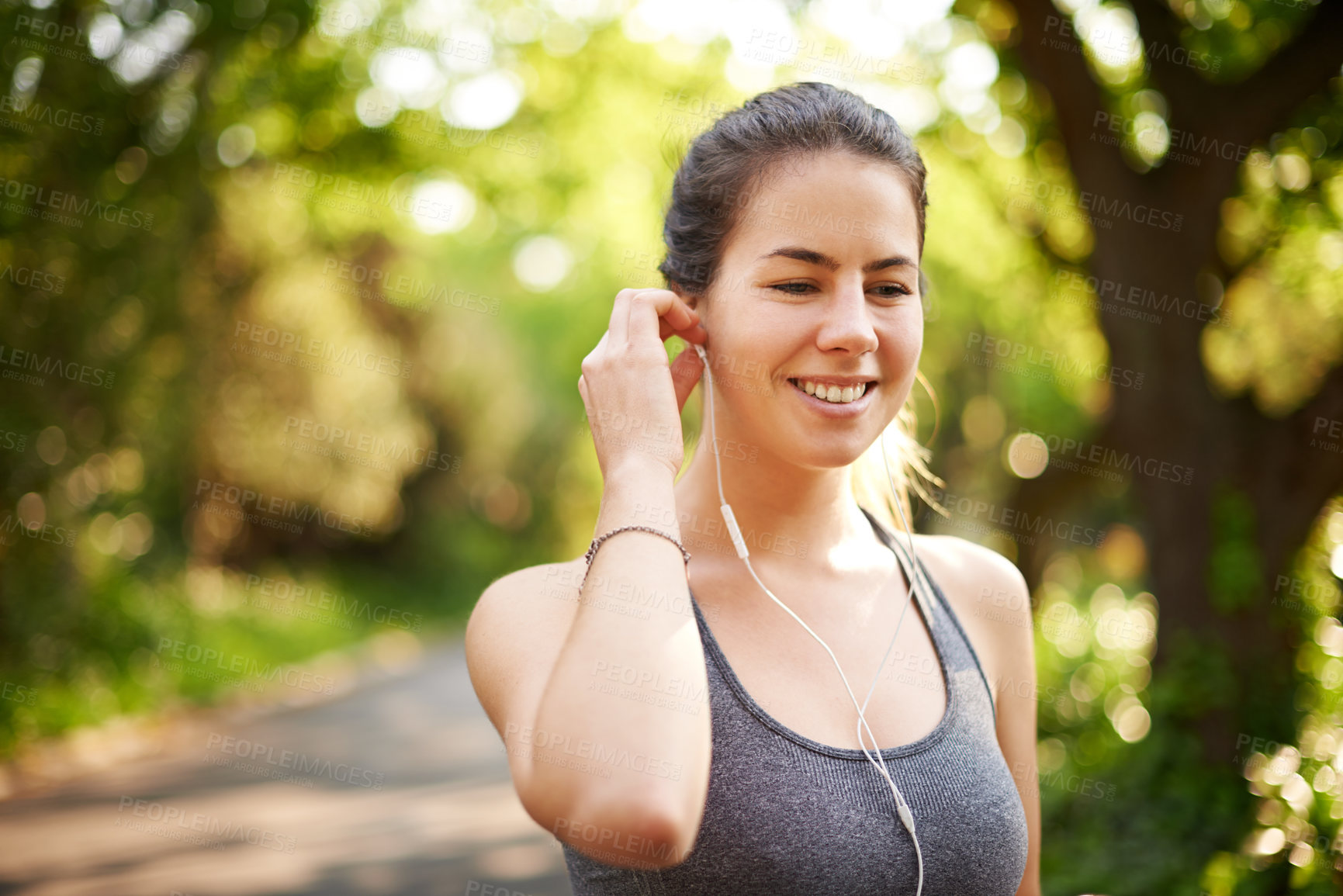Buy stock photo Athlete, fitness and woman with music at park for cardio break, online running tips and relax with audio. Runner, space and earphones in nature for workout, listening to radio and happy for resting