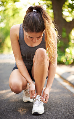 Buy stock photo Woman, fitness and tie laces on road with crouch, start and ready for run in park. Runner, asphalt and tying sneakers outdoor for wellness, sports and break with training commitment on Italy street