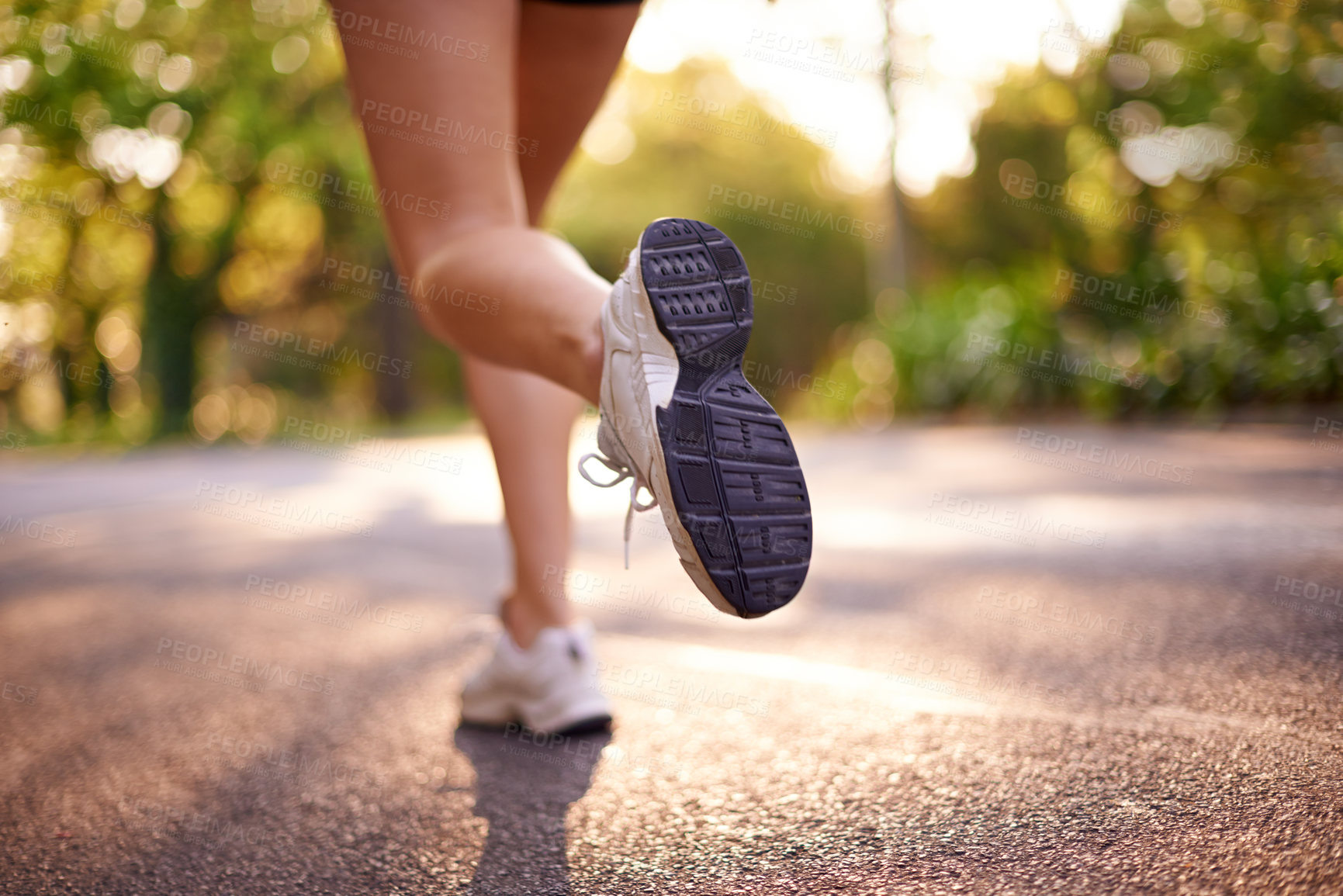 Buy stock photo Running, legs and fitness with back of woman in road for marathon practice, workout and cardio. Wellness, exercise and sports training with closeup of person for race, energy and athlete progress