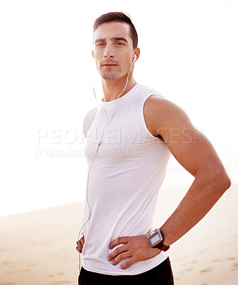Buy stock photo Fitness, beach and portrait of man with earphones for running with music, album or playlist for challenge. Sport, workout and athlete with audio tech for race, marathon or endurance training by ocean