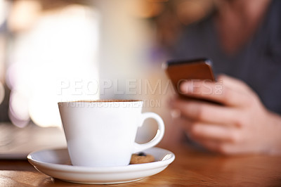Buy stock photo Hand, mobile and person with coffee cup, typing text or writing review for drink closeup. Cafe table, phone or chat notification, communication or influencer post latte on social media profile online