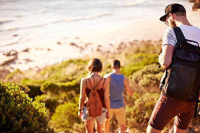 Buy stock photo Walking, travel and friends by beach for journey, weekend trip or adventure on seaside vacation. Discovery, fun and back of people by ocean for holiday or getaway in nature together for bonding.