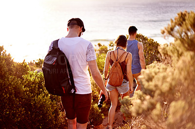 Buy stock photo Walking, travel and group of people by beach for journey, weekend trip or adventure on seaside vacation. Discovery, fun and back of friends by ocean for holiday or getaway in nature for bonding.