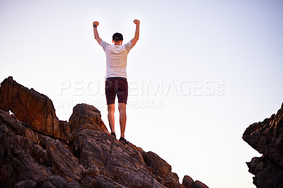 Buy stock photo Celebration, rock climber and man on mountain, back and achievement for hiking in nature and outdoor. Mockup space, blue sky and person with victory for freedom, travel and accomplishment in morning
